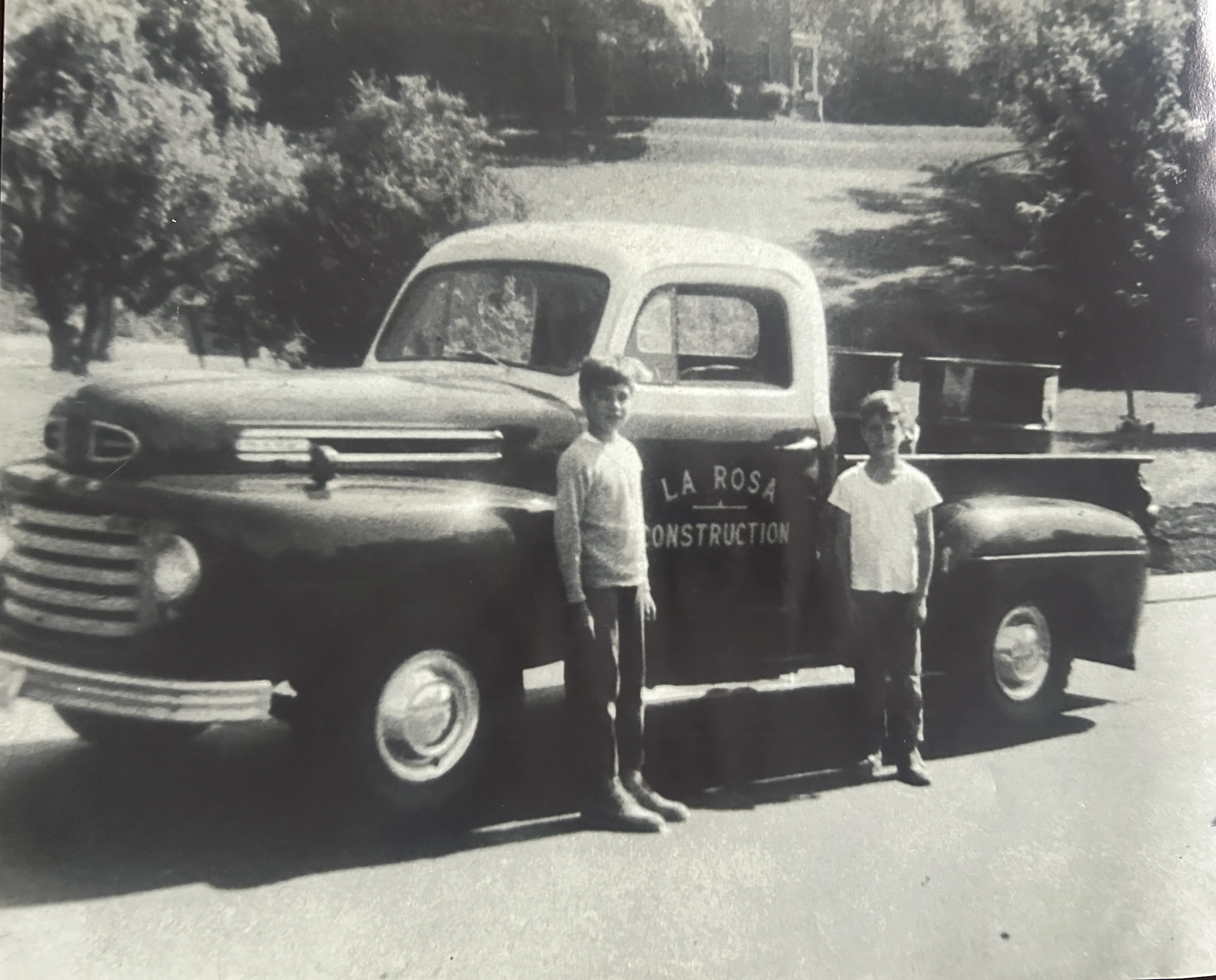 The founder&rsquo;s young sons pose in front of a Ford F-Series pickup truck with the LaRosa Construction logo in the 1950s.