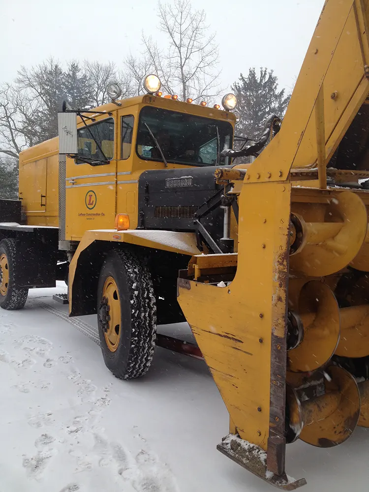 Close-up of a snow blower truck with the LaRosa Construction logo visible on the door.