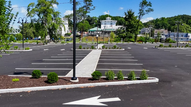 The freshly paved Goodspeed Opera House parking lot with a concrete pedestrian walkway shown at center.