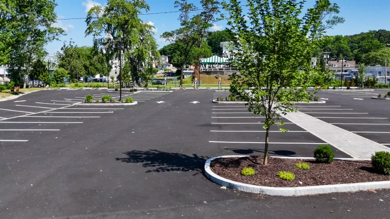 The Goodspeed Opera House parking lot with fresh black asphalt, white line markings, and landscaped areas.