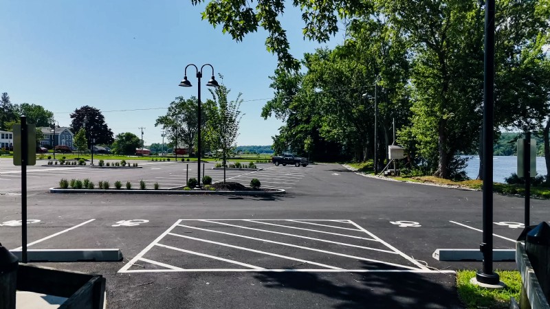 Parking lot with handicap spaces in the foreground and the Connecticut River in the background.