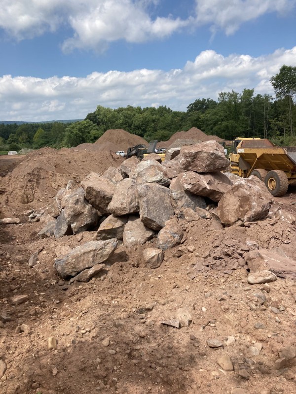 A pile of large rocks excavated from the construction site.