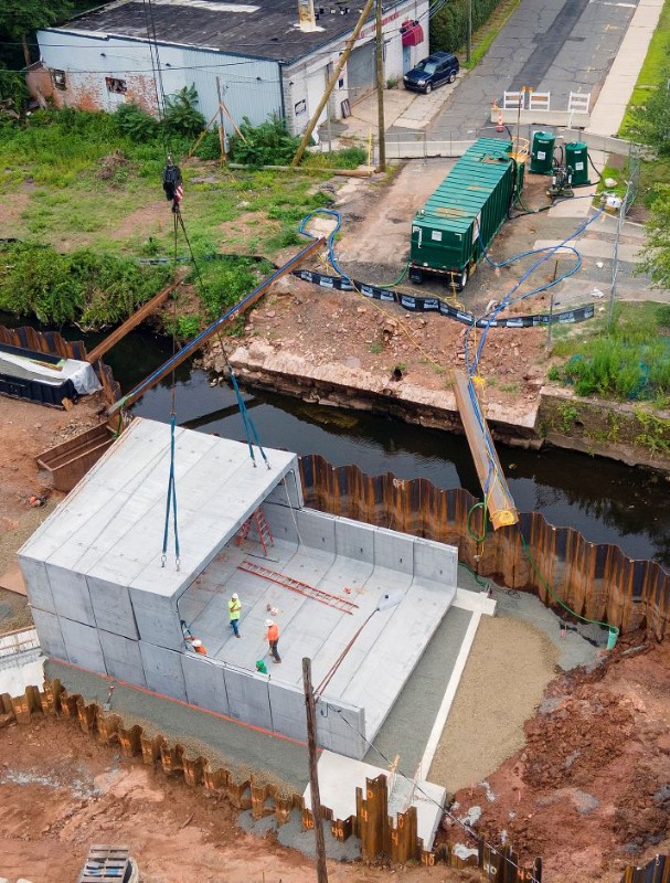 Aerial view from the right of a new concrete box culvert being installed in Harbor Brook.