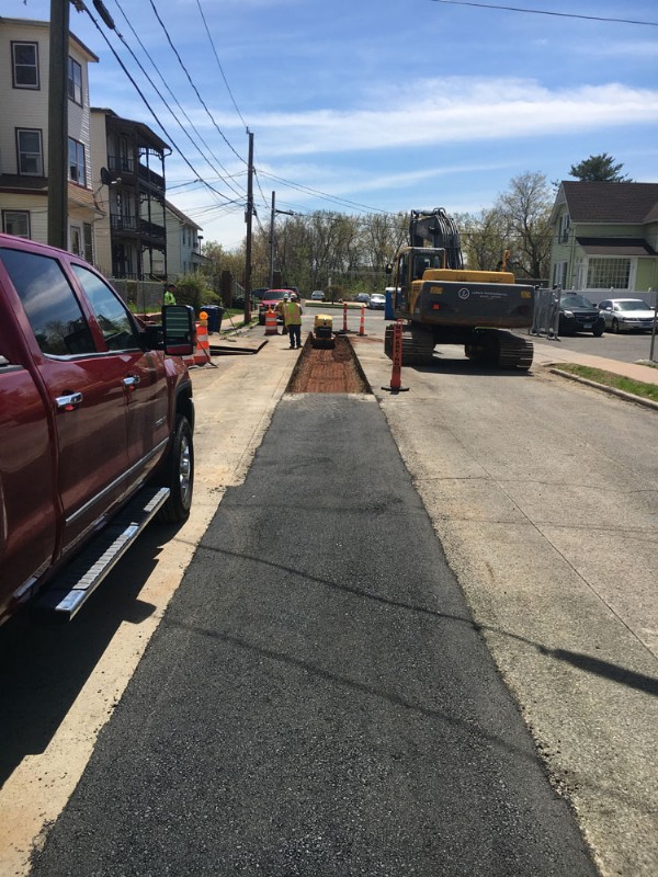 Paving of the excavated area of the road after pipeline repairs were completed.