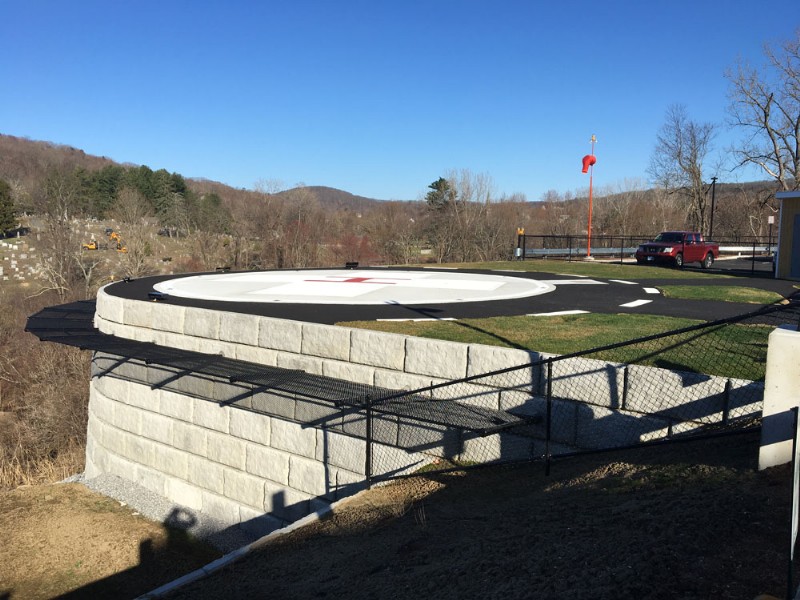 A side view of the newly installed helicopter landing pad, built atop a concrete retaining wall.