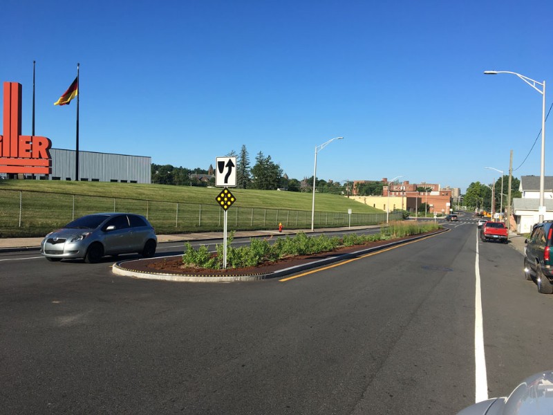 A pedestrian refuge island between two lanes of the road.