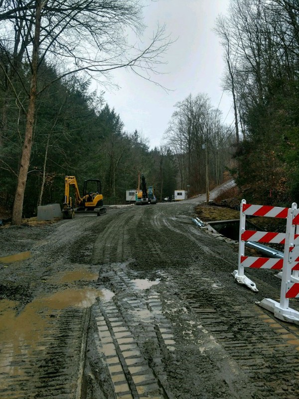 The roadway above the bridge being reconstructed, with heavy machinery in the background.