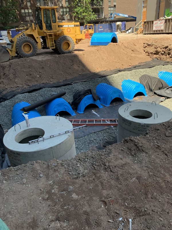 A stormwater management system being installed in an excavated trench.