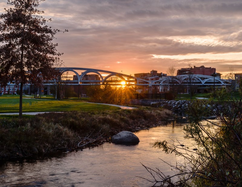 The bridge on the Meriden Green seen at sunset after the project completion, with Harbor Brook in the foreground.