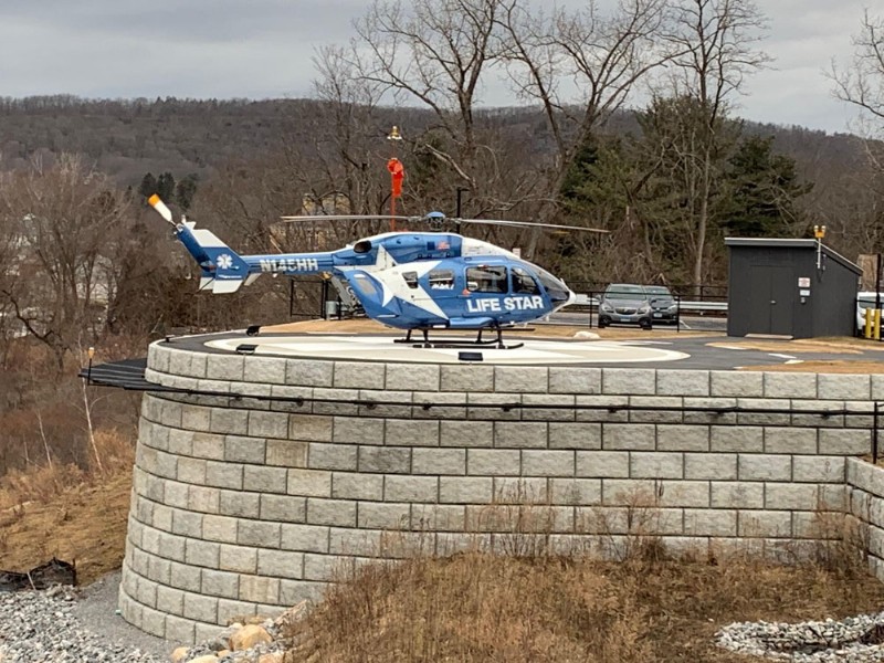 A Life Star helicopter sits atop the helipad above the new retaining wall.