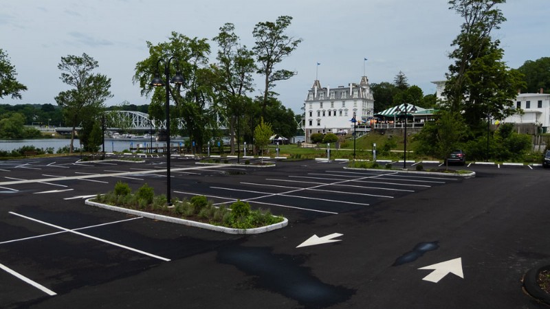 Freshly paved parking lot with the Goodspeed Opera House and the East Haddam Swing Bridge in the background.